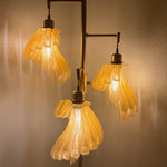Arise Arbor Floor Lamp, amber shades lit in the evening