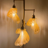 Arise Arbor Floor Lamp, amber shades lit in the evening