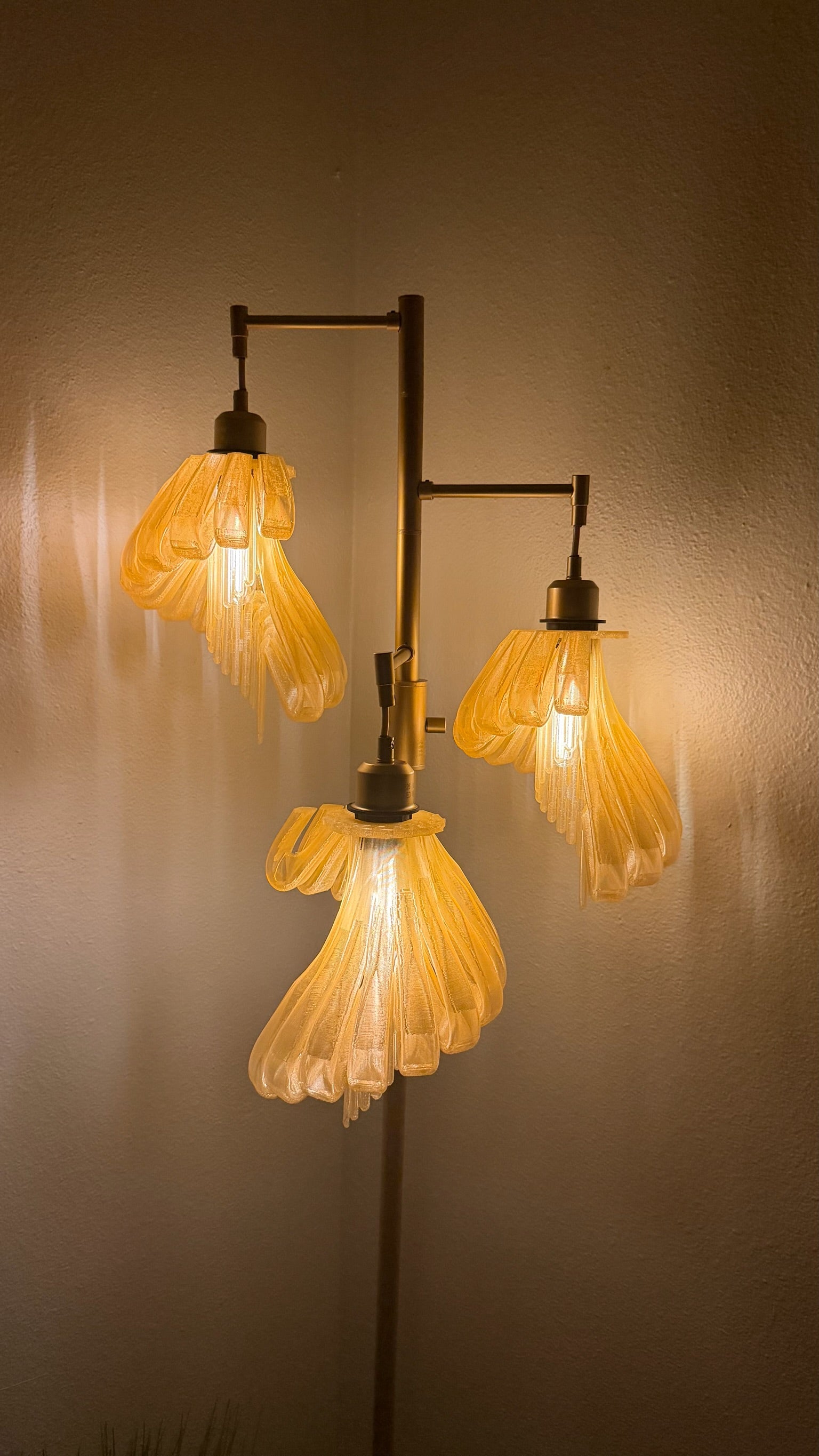 Arise Arbor Floor Lamp, amber shades lit in the evening