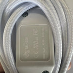 Close-up of the white inline switch showing safety markings
