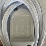 Close-up of the white inline switch showing safety markings