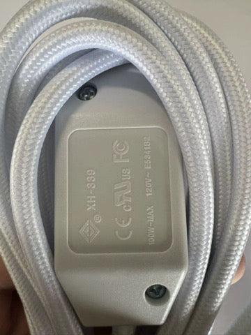 Close-up of the white inline switch showing safety markings
