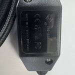 Close-up of the black inline switch showing safety markings