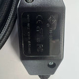 Close-up of the black inline switch showing safety markings