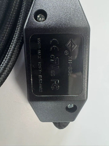 Close-up of the black inline switch showing safety markings
