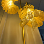 Arise Arbor Floor Lamp, amber shades glowing