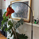 Arc Arise Standing Lamp with black base in a living room