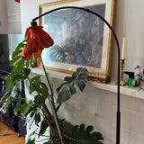 Arc Arise Standing Lamp with black base in a living room