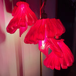 Arise Arbor Floor Lamp, red shades casting pink light