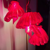 Arise Arbor Floor Lamp, red shades casting pink light