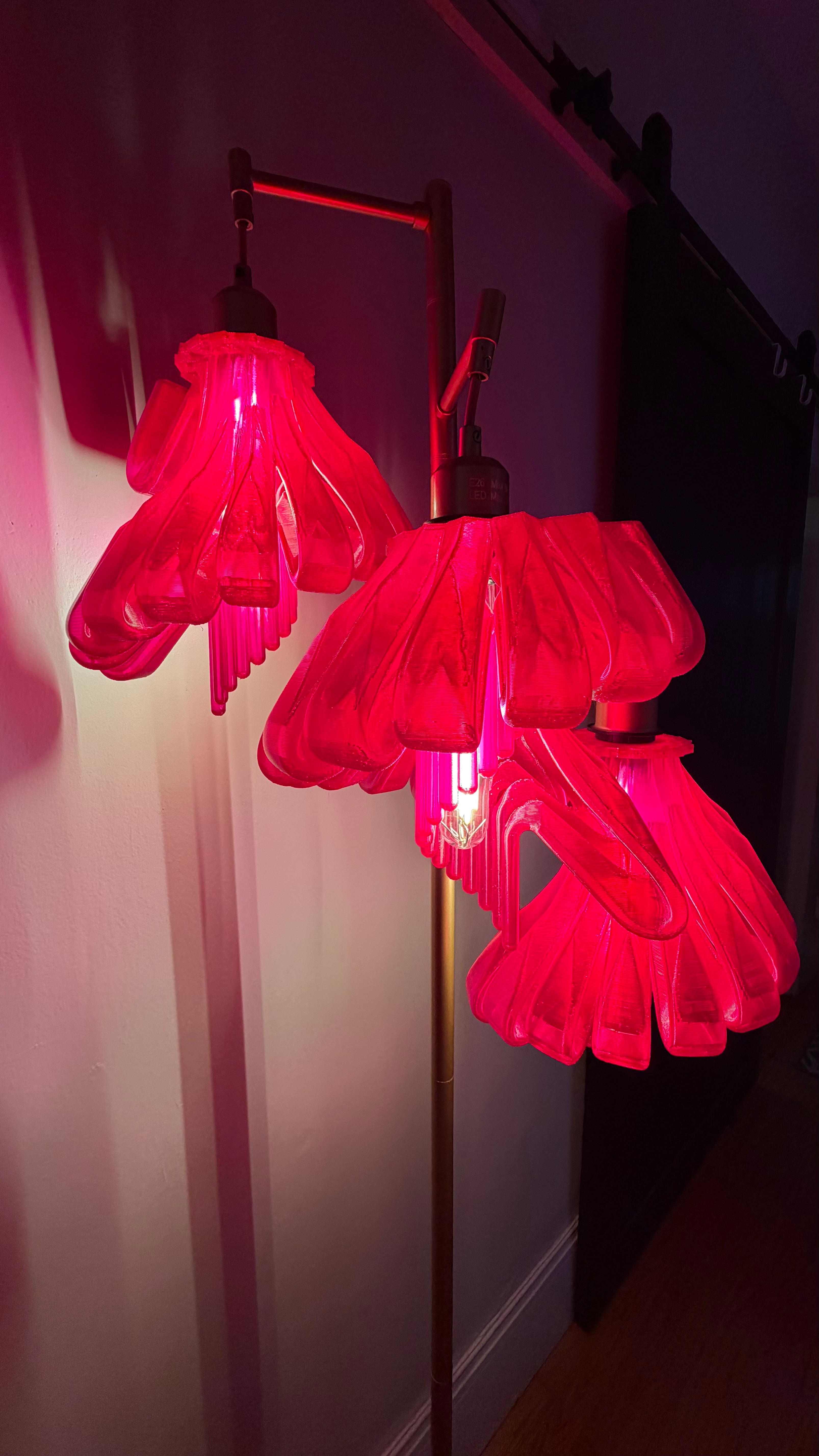 Arise Arbor Floor Lamp, red shades casting pink light