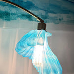 Arc Arise Standing Lamp, blue shade lit close-up