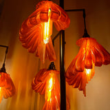 Arise Arbor Floor Lamp, mixed orange shades lit